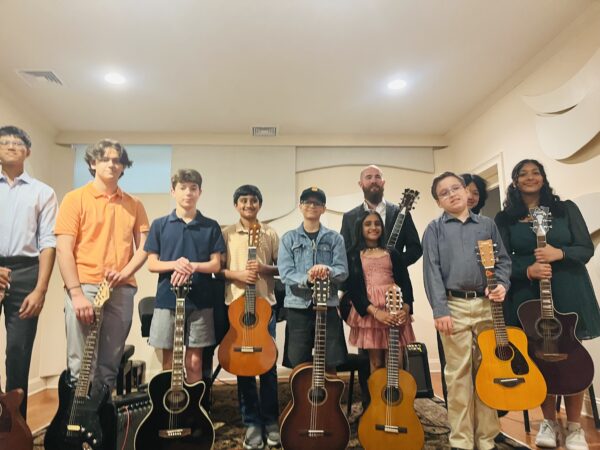 Student and Chris playing guitar together